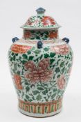 A Chinese Wucai jar and matched cover: the baluster jar with four lug handles enamelled in red and