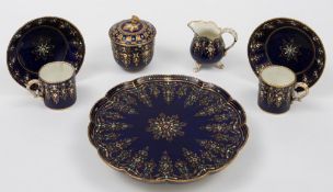 A later decorated Sèvres porcelain tête-à-tête: comprising a footed tray, sucrier and cover,