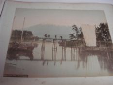 A JAPANESE PHOTOGRAPH ALBUM: 52 hand-tinted photographs 260 x 195mm, ob. 4to.