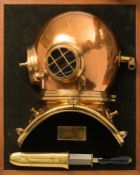 A display mounted half section 6-bolt 'Pearler' diving helmet and diver's knife by Siebe Gorman &