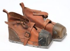 A pair of American diving boots:, the ridged sole attached to a maple base with brown leather upper,