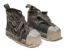 A pair of lead soled diving boots worn by Lloyd Scott for the London Marathon in 2002:,