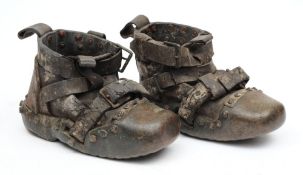 A pair of used brass sand shoes:,
