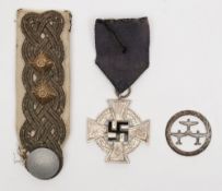 A WWII German Merit Cross together with a Luftwaffe epaulette and badge:.
