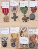 A collection of eight WWI and WWII service medals:, various countries including France, Germany,