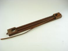 A mahogany two division game carrier with leather strap:, 61cm long.