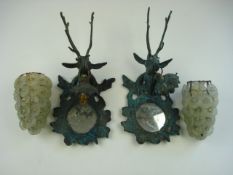 A pair of brass stag's head wall lights with floral pattern glass shades:, .
