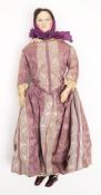 A 19th century shoulder headed doll:, applied brunette wig and painted face on a kid leather body,
