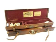 A brown leather gun case with label for William Powell & Sons Birmingham and one other gun case:,