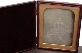 A Victorian quarter plate daguerreotype of a seated child with a basket of flowers:, unsigned,