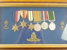A framed WWII group of six together with cap and shoulder badges:,