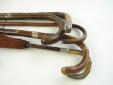 Four silver mounted walking sticks and a silver mounted horn handled umbrella:,
