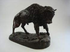 After Leon Mignon, a bronzed spelter figure of a Bison:, standing on a naturalistic base, 33cm high.