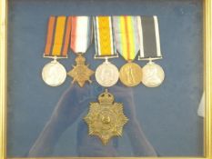 A framed group of WWI medals and cap badge:, QSA, 1914-15 Star (reproduction) War Medal,