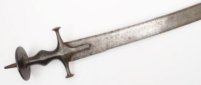 An 18th/19th century Indian Tulwar:, of typical form with curved blade and plain steel handle,