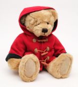 A brown plush Harrods Christmas bear 2003:, in a red duffel coat.