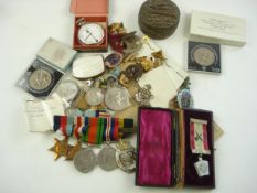 A group of five WWII service medals, together with a collection of miniatures, cap badges,