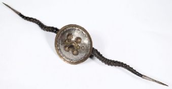 In Indian Madu: the central circular shield with short spike and four bosses,