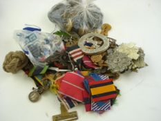 A collection of various British Regimental cap badges and medal ribbons:.