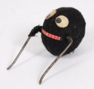 A felt covered clockwork spider:. 7cm. long.