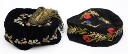 Two early 20th century smoking caps:, both with floral embroidered decoration ,