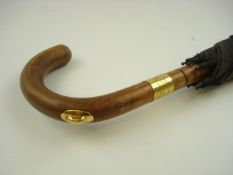 An 18ct gold mounted umbrella by Brigg & Son of London:, makers marks for Brigg & Son, London 1886,
