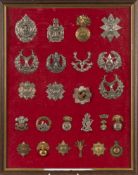 Twenty four WW1/ WW2 infantry and guards regimental cap badges:. mounted and framed.