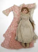 A German bisque shoulder headed doll:, applied blonde wig, fixed brown glass eyes,