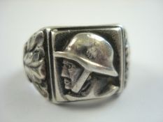A WWII German Totenkopf style ring:, with portrait of a soldier flanked by oak leaves,