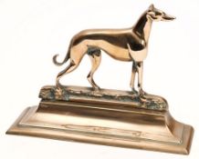 A brass doorstop in the form of a greyhound on downswept base:, 23cm high.