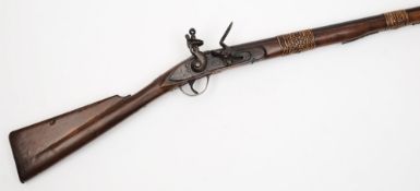 A 19th century flintlock longarm, probably Indian:,