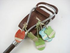 A 'Triton' shooting stick with a number of guest badges to frame circa 1980s:.