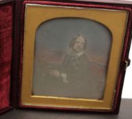 A hand coloured daguerreotype of a seated woman by Mayall of London:,