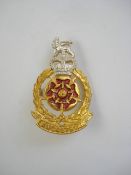 A Queen's Lancashire Regiment cap badge by J R Gaunt , London:, one bar missing to reverse..