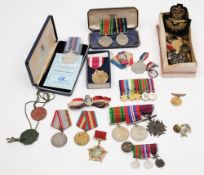 A small collection of WWII service medals:, together with cap and shoulder badges,