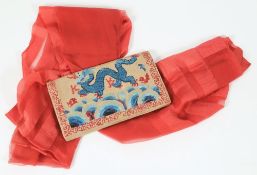 An early 20th century beadwork and silk evening bag: with dragon decoration and a red silk evening