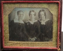 A Victorian quarter plate daguerreotype of a group of three women:, in an embossed leather case.