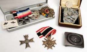 Two German 1939 Merit crosses, an Iron Cross (Second Class),