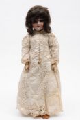 A Schoenau & Hoffmeister bisque head doll:, applied black wig, blue glass sleeping eyes,