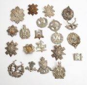 A collection of Scottish regiment cap badges and helmet plates:.