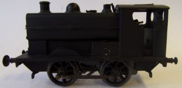 An O gauge 0-4-0 clockwork saddle tank locomotive: in black livery.