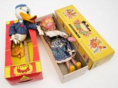 Two Pelham puppets 'Donald Duck' and 'Mitzy, together with a Monopoly set:.