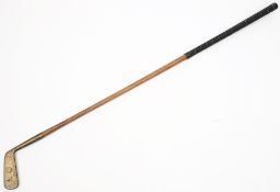 An early 20th century brass head putter by R Simpson Carnoustie:, on a hickory shaft, 90cm long.