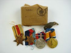 A WWI Victory medal and three WWII service medals:, also together with a WWI identity tag,
