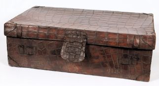 An early 20th century brown leather crocodile skin suitcase:, the top stencilled 'Morgan,