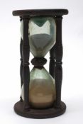 A late 18th/early 19th century sandglass:, unsigned, of traditional form with four turned pillars,
