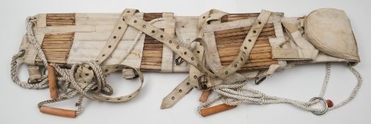 A Neil Robertson ship's stretcher:, of traditional form in white canvas.