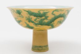 A Chinese porcelain sgrafitto decorated yellow ground stem bowl: the exterior incised and picked