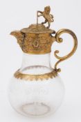 A Victorian glass and gilt metal mounted claret jug: of baluster form,