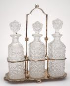 A silver plated three-division decanter stand by Walker & Hall: of rectangular outline,